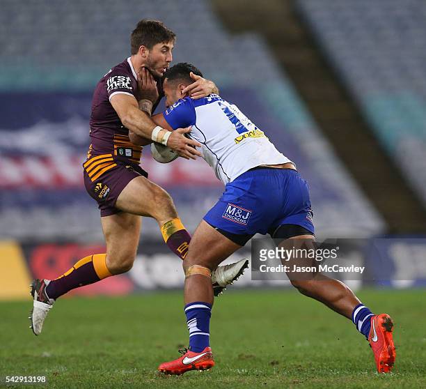 Tony Williams of the Bulldogs is tackled by Ben Hunt of the Broncos during the round 16 NRL match between the Canterbury Bulldogs and Brisbane...