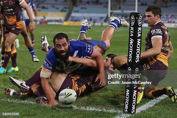 Sam Kasiano of the Bulldogs scores a try during the round 16 NRL match between the Canterbury Bulldogs and Brisbane Broncos at ANZ Stadium on June...