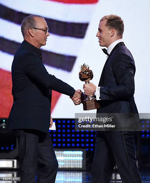 Actor Michael Keaton presents the Hart Trophy to Patrick Kane of the Chicago Blackhawks during the 2016 NHL Awards at The Joint inside the Hard Rock...