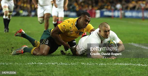 Mike Brown of England holds off Tevita Kuridrani to score their second try during the International Test match between the Australian Wallabies and...