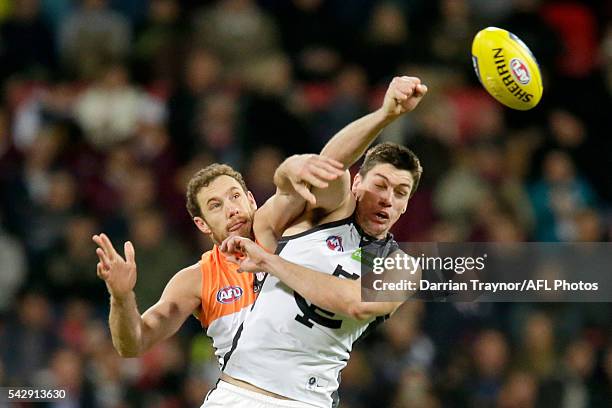 Shane Mumford of the Giants and Matthew Kreuzer of the Blues compete in the ruck during the round 14 AFL match between the Greater Western Sydney...