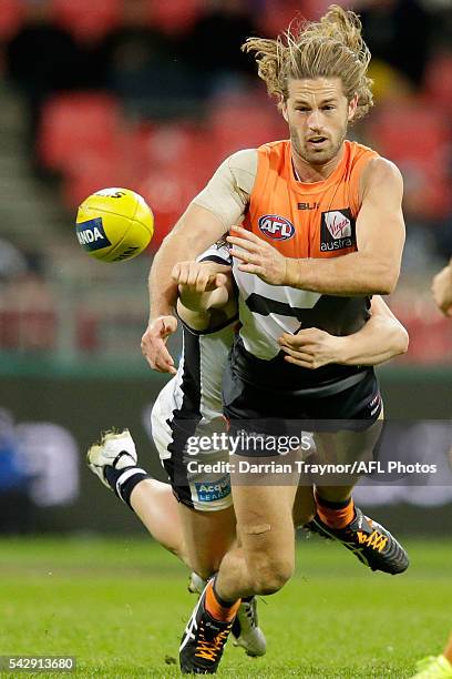 Callan Ward of the Giants handballs during the round 14 AFL match between the Greater Western Sydney Giants and the Carlton Blues at Spotless Stadium...