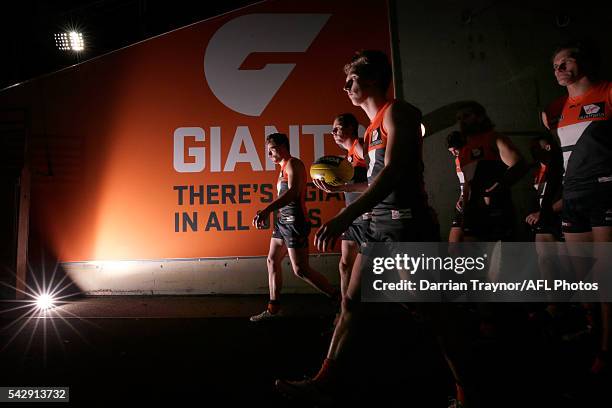 Giants players walk onto the ground after the half time break during the round 14 AFL match between the Greater Western Sydney Giants and the Carlton...