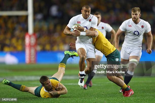 Rob Horne of the Wallabies misses a tackle on Jonathan Joseph of England during the International Test match between the Australian Wallabies and...