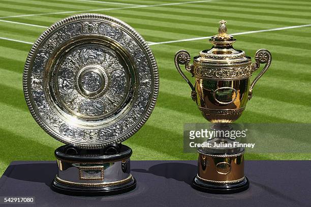 The Gentlemen's and Ladies' trophies are seen on centre court during previews for Wimbledon Tennis 2016 at Wimbledon on June 25, 2016 in London,...