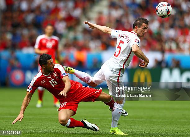 Blerim Dzemaili of Switzerland and Krzysztof Maczynski of Poland compete for the ball during the UEFA EURO 2016 round of 16 match between Switzerland...