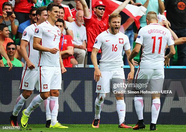 Jakub Blaszczykowski of Poland celebrates scoring his team's first goal with his team mates during the UEFA EURO 2016 round of 16 match between...