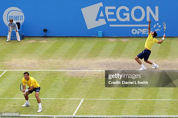 Marcelo Melo of Brazil serves with Ivan Dodig of Croatia during their men's doubles final match against Daniel Nestor of Canada and Dominic Inglot of...