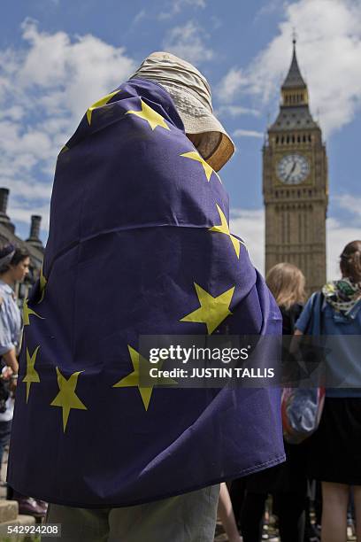 Demonstrator draped in an EU flag takes part in a protest against the pro-Brexit outcome of the UK's June 23 referendum on the European Union , in...