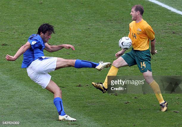 Australian defender Scott Chipperfield blocks a shot by Italian forward Luca Toni in the round of 16 World Cup 2006 football match between Italy and...