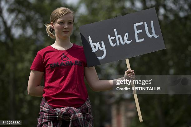 Demonstrator holds a placard during a protest against the pro-Brexit outcome of the UK's June 23 referendum on the European Union , in central London...