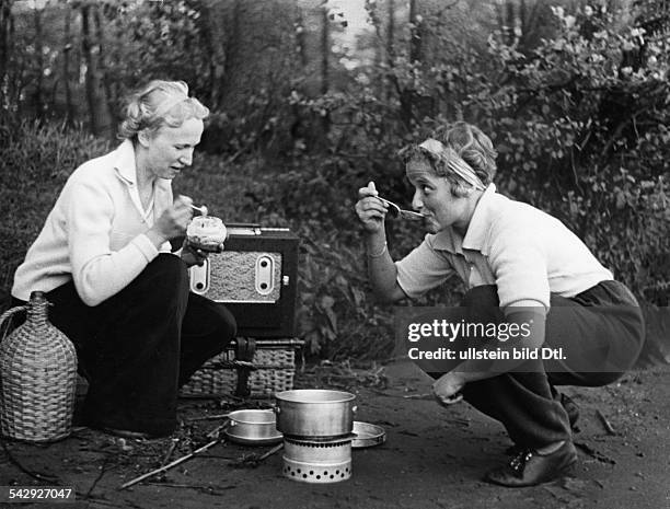 Spare time pictures Two women cooking on a camping stove and listening to a portable radio - 1938 - Published by: 'Hier Berlin' 23/1938 Vintage...