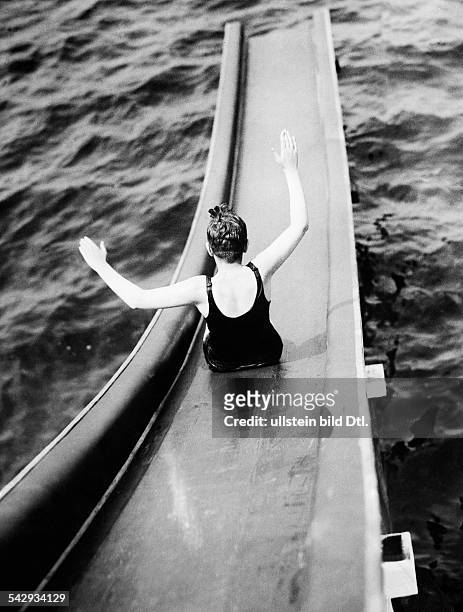 Germany Free State Prussia Berlin Berlin: Bathing season at Lake Wannsee, Berlin a kid on the waterslide at Wannsee lido - 1929 - Vintage property of...