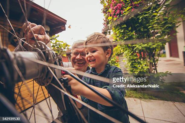 little repairman and his grandfather - extended family outdoors spring stock pictures, royalty-free photos & images