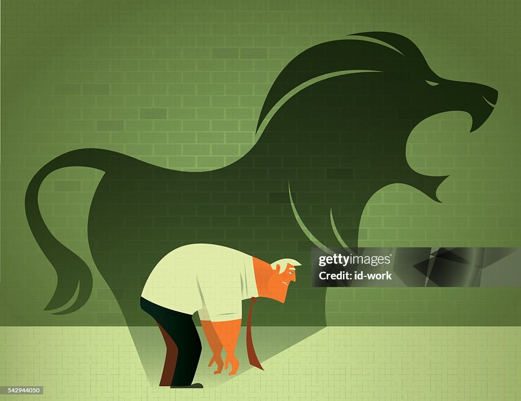 Sad businessman with angry lion shadow