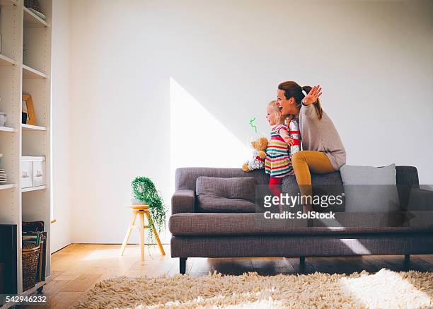lets pretend! - family on couch stock pictures, royalty-free photos & images