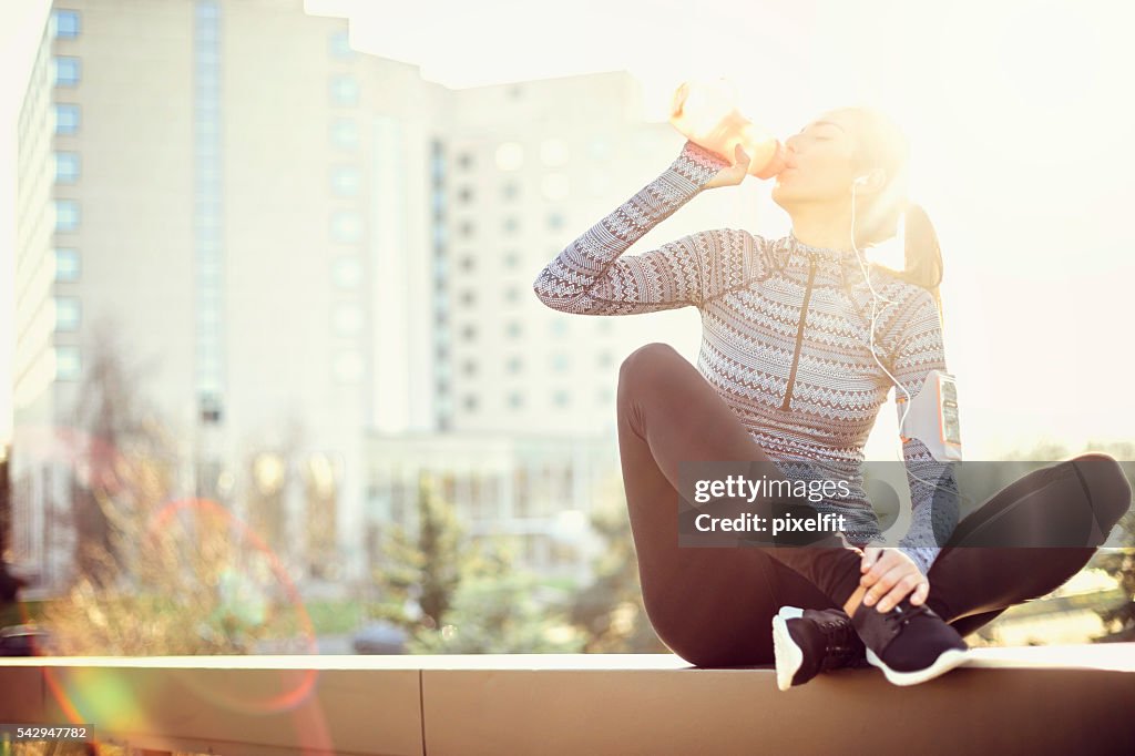 Sports woman drinking water