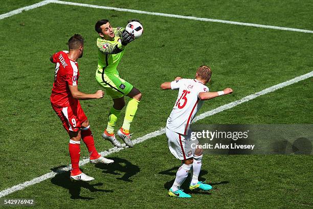 Lukasz Fabianski of Poland catches the ball in front of Haris Seferovic of Switzerland during the UEFA EURO 2016 round of 16 match between...