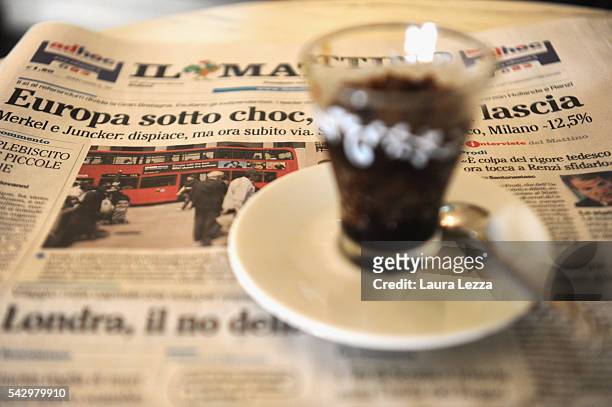 An Italian newspaper declaring about Brexit and UK leaving the European Union is displayed inside a bar with ice coffee on June 25, 2016 in the town...