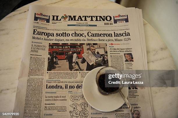 An Italian newspaper declaring about Brexit and UK leaving the European Union is displayed inside a bar with ice cffee on June 25, 2016 in the town...