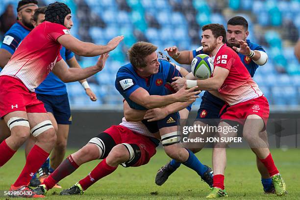 France's Anthony Jelonch off-loads the ball as he is tackled by Georgia's captain Vasil Lobzhanidze during the World Rugby U20 Championship 2016, 9th...