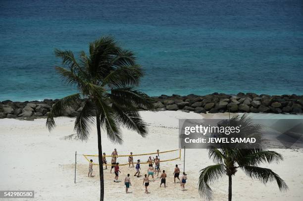 Group of tourists play beach volleyball in Barbados on June 25, 2016.