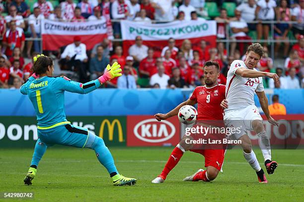 Lukasz Piszczek of Poland competes for the ball against Haris Seferovic and Yann Sommer of Switzerland during the UEFA EURO 2016 round of 16 match...