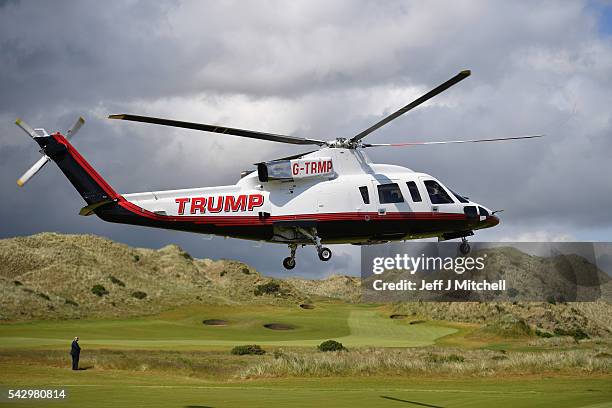 Presumptive Republican nominee for US president Donald Trump arrives in a helicopter at Trump International Golf Links on June 25, 2016 in Aberdeen,...