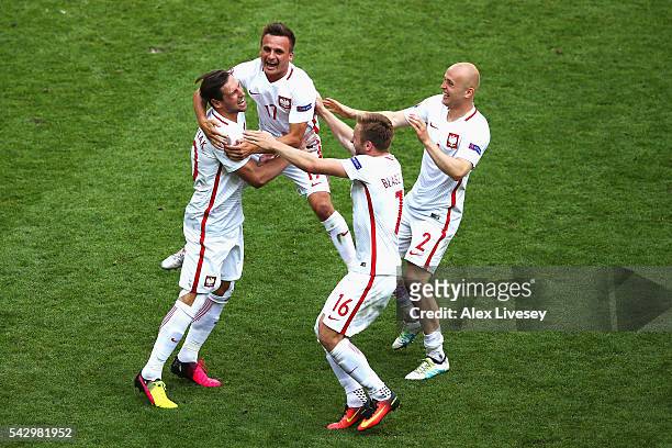 Grzegorz Krychowiak, Slawomir Peszko, Jakub Blaszczykowski and Michal Pazdan of Poland celebrate their win through the penalty shootout after the...
