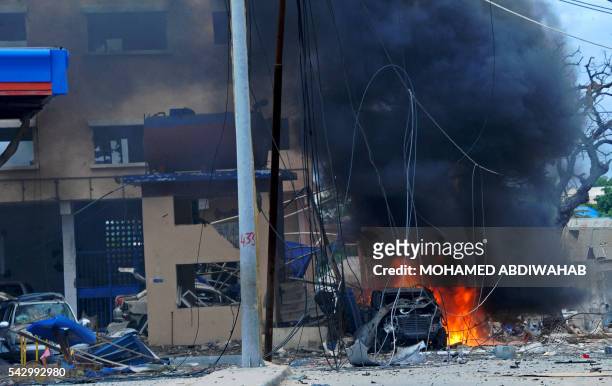 Fire is seen at the scene of a car bomb attack claimed by Al-Qaeda-affiliated Shabaab militants which killed at least 5 people, on the Naasa Hablood...