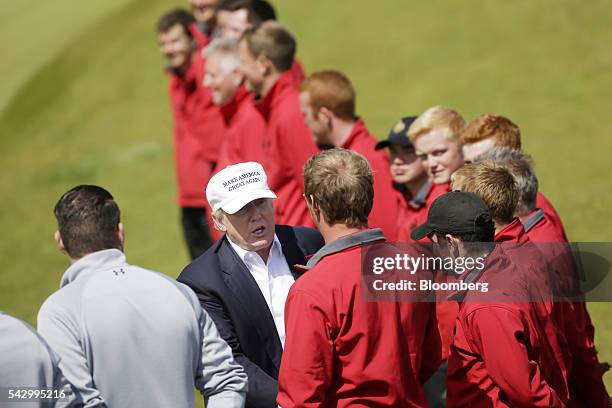 Donald Trump, presumptive Republican presidential nominee, greets supporters as he arrives at Trump International Golf Links in Aberdeen, U.K, on...