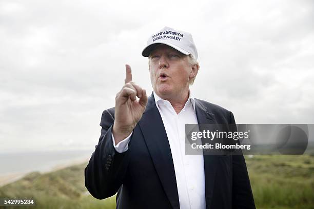 Donald Trump, presumptive Republican presidential nominee, gestures as he speaks to members of the media at Trump International Golf Links in...