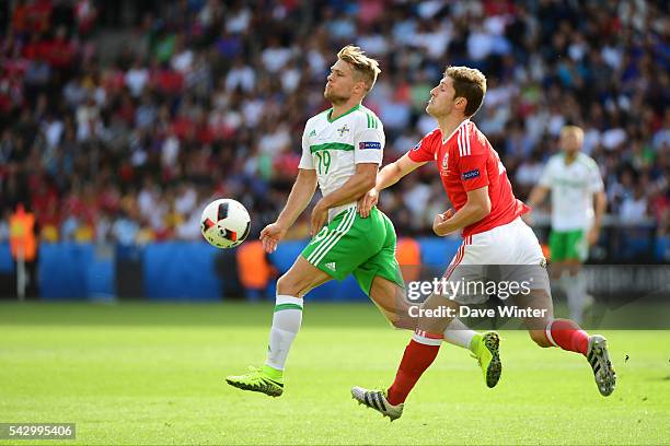 Jamie Ward of Northern Ireland and Neil Taylor of Wales during the European Championship match Round of 16 between Wales and Northern Ireland at Parc...