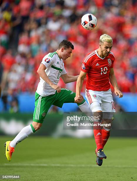 Aaron Ramsey of Wales and Corry Evans of Northern Ireland compete for the ball during the UEFA EURO 2016 round of 16 match between Wales and Northern...