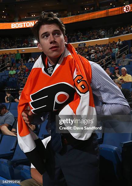 Carter Hart puts on his jersey after being selected 48th overall by the Philadelphia Flyers during the 2016 NHL Draft at First Niagara Center on June...