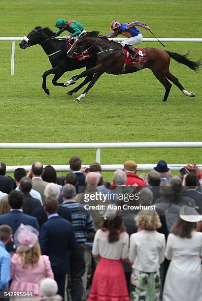 Pat Smullen riding Harzand win The Dubai Duty Free Irish Derby from Idaho and Ryan Moore at Curragh racecourse on June 25, 2016 in Kildare, Ireland.