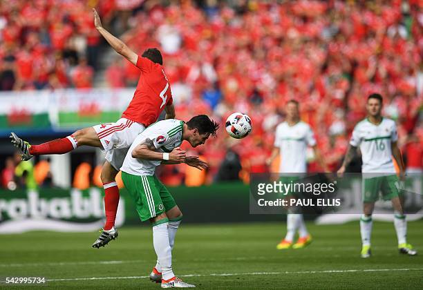 Wales' defender Ben Davies vies for the header with Northern Ireland's forward Kyle Lafferty during the Euro 2016 round of sixteen football match...