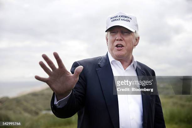 Donald Trump, presumptive Republican presidential nominee, gestures as he speaks to members of the media at Trump International Golf Links in...