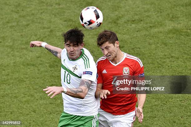 Northern Ireland's forward Kyle Lafferty vies for the ball against Wales' defender Ben Davies during the Euro 2016 round of sixteen football match...