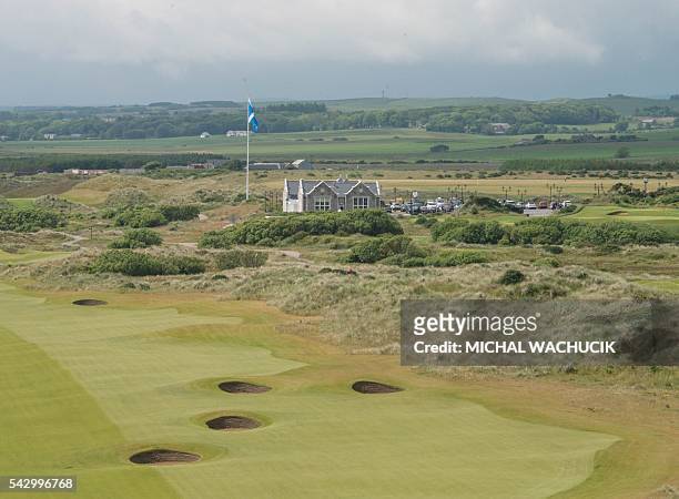 Donald Trump's International Golf Links course clubhouse is pictured behind the 18th hole, north of Aberdeen on the east coast of Scotland on June...