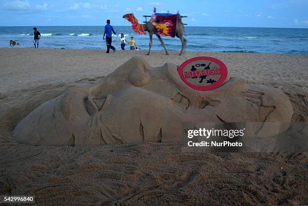 Visitors look near to the Rio Olympic sand sculpture, creating by sand artist Sudarshan Pattnaik after Indian runner Dutee Chand qualify for upcoming...