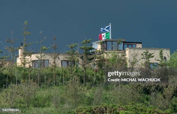 David Milne's house is pictured with Scottish and Mexican Flags erected in protest against Trump beside Donald Trump's International Golf Links...