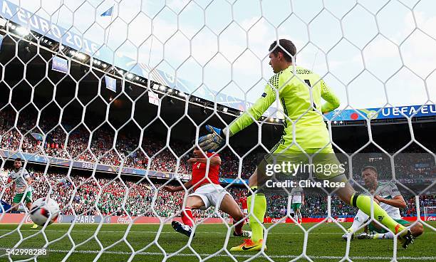 Michael McGovern of Northern Ireland watches the ball as his team mate Gareth McAuley scores an own goal during the UEFA EURO 2016 round of 16 match...