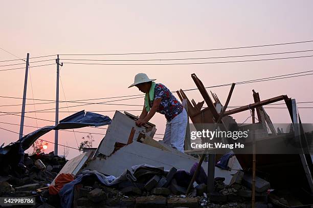 Villager searches for undamaged articles at her house in Beichen Village of Chenliang Township in Funing, Yancheng, east China's Jiangsu Province on...