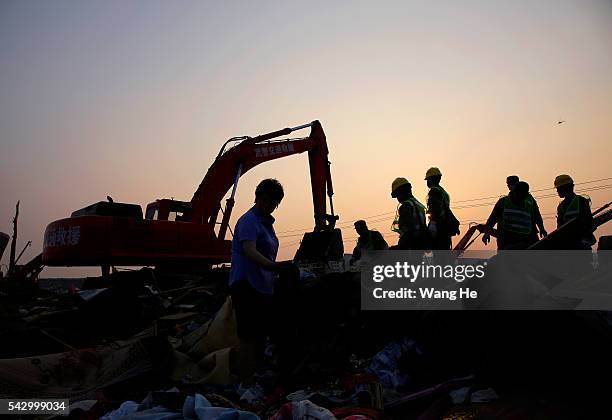 Rescue machinery is used to clean up damaged houses in Beichen Village of Chenliang Township in Funing, Yancheng, east China's Jiangsu Province on...