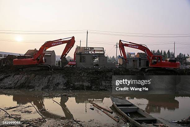 Rescue machinery is used to clean up damaged houses in Beichen Village of Chenliang Township in Funing, Yancheng, east China's Jiangsu Province on...