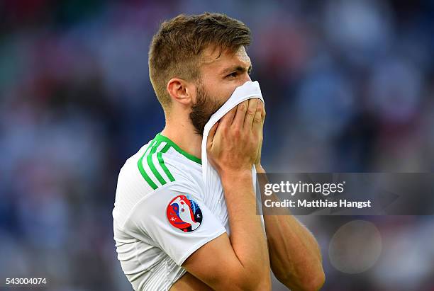 Stuart Dallas of Northern Ireland shows his dejection after his team's 0-1 defeat in the UEFA EURO 2016 round of 16 match between Wales and Northern...