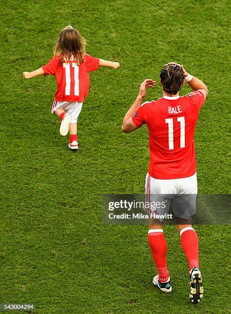 Gareth Bale of Wales celebrates his team's win with his daughter Alba Violet after the UEFA EURO 2016 round of 16 match between Wales and Northern...