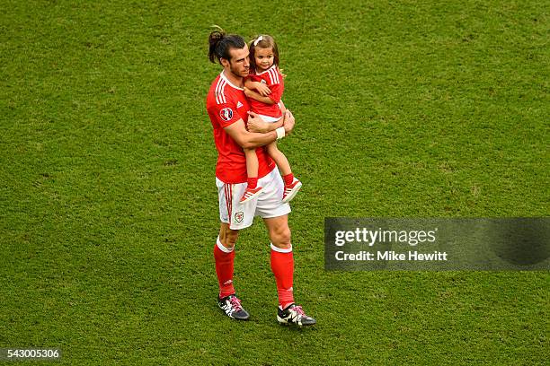 Gareth Bale of Wales celebrates his team's win with his daughter Alba Violet after the UEFA EURO 2016 round of 16 match between Wales and Northern...