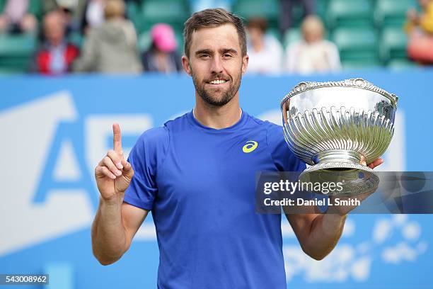 Steve Johnson of the United States poses with his trophy after defeating Pablo Cuevas of Uruguay in his men's singles final match during day six of...